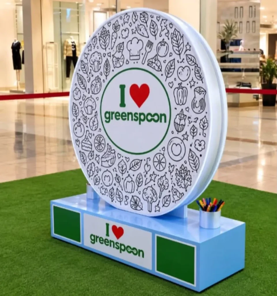 Branded free-standing display stand for Greenspoon in a shopping mall