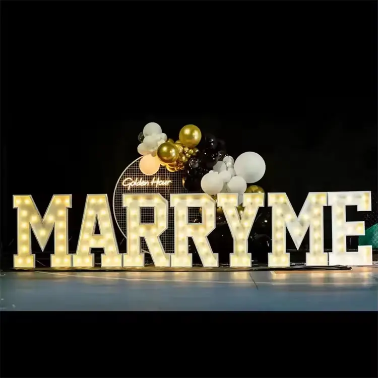 Marry Me marquee light-up letters at an event