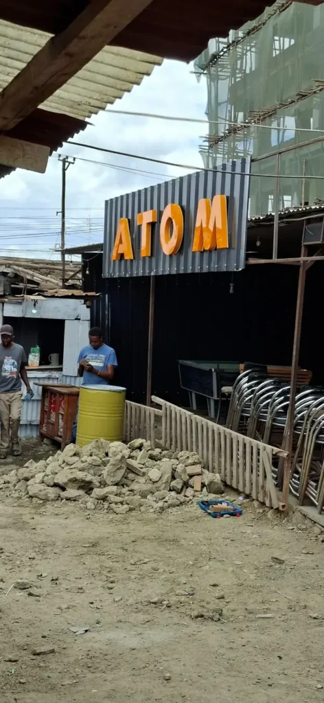 ATOM building sign during installation
