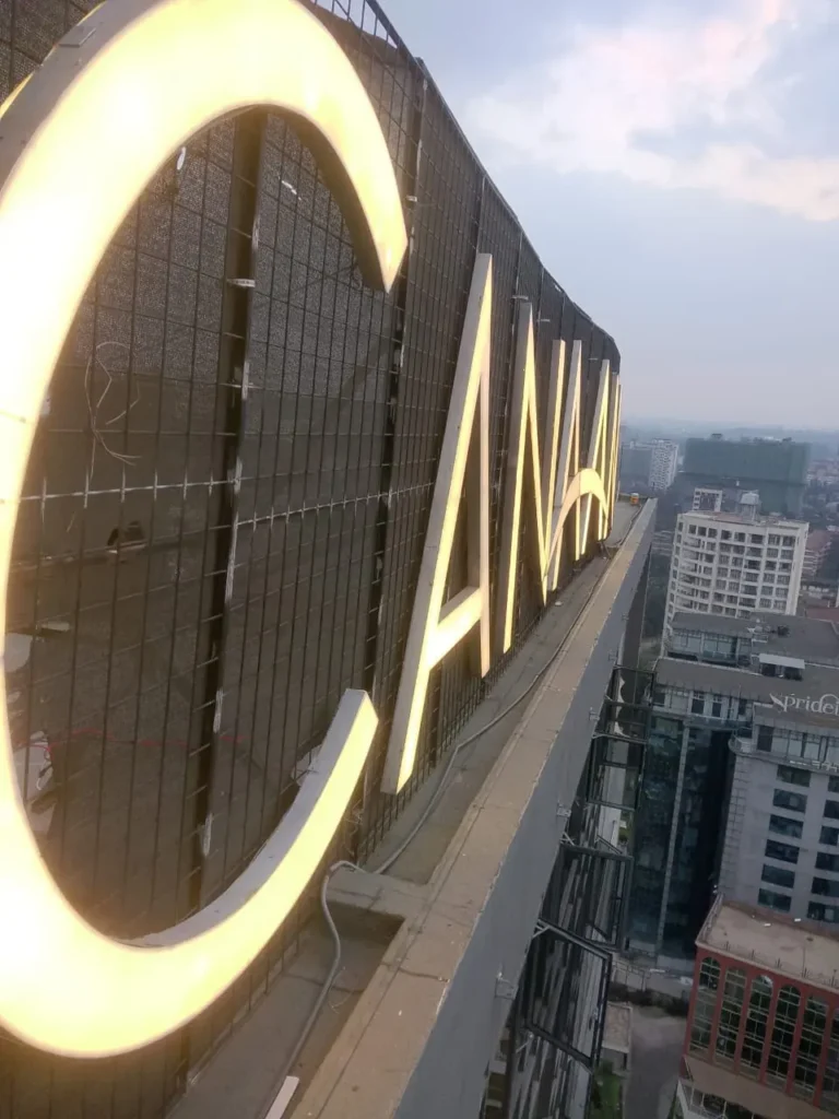 Illuminated rooftop letters above the city