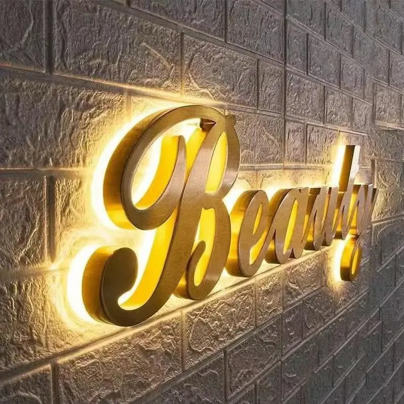 Gold Beauty script sign on a brick wall