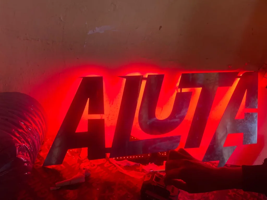 Red illuminated ALUTA letters