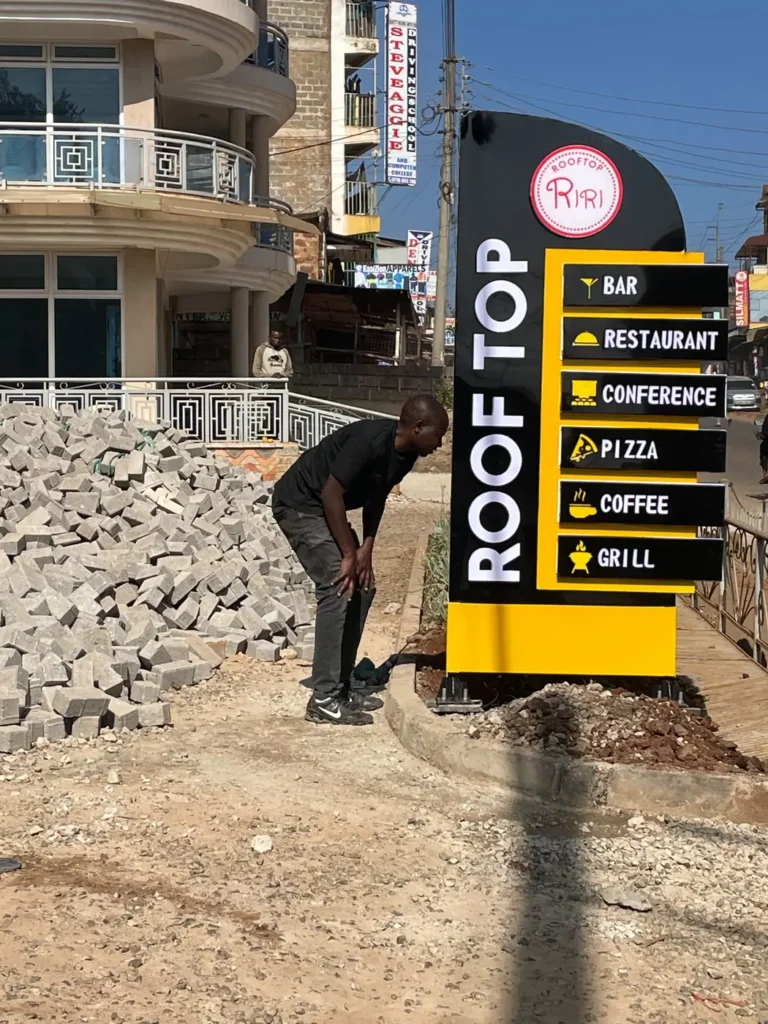 Rooftop pylon directory sign being installed