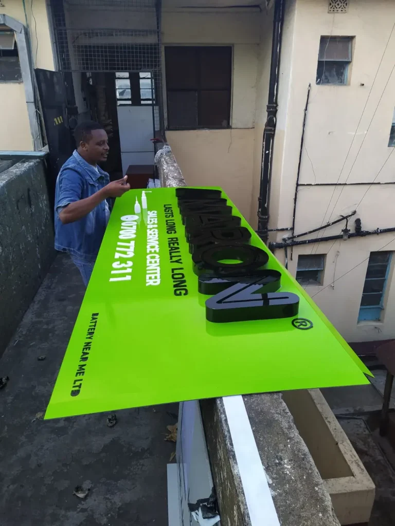 Fitting letters onto a bright green fascia board